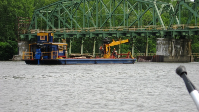 Canal workers removing logs