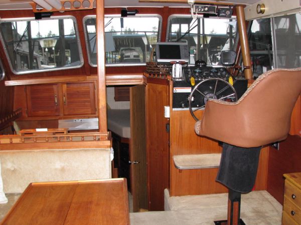 Captains chair on electric shaft so it can be lowered to the same level as the salon seating.