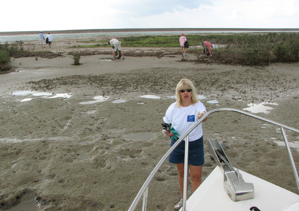 Climbing off the bow to do some bay clean up