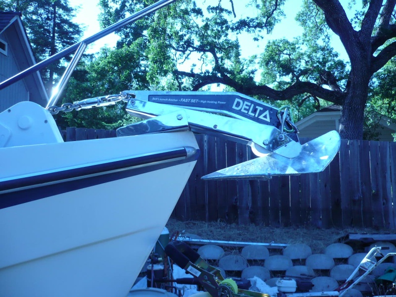 Close Fit. New Delta 14 Fast set just clears (old Bruce 11 had plenty of room)as the auto launch drops. Note second shackle at top of anchor allows simple clip to top of roller bar for trailering security. Stainless shackle and SS swivel also just fit in front of windlass even at full tension. Shackle\swivel combo eliminates most of the possibility of side loading on the swivel (I think).