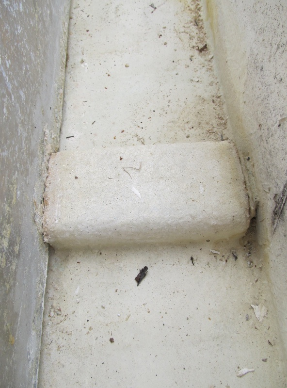 close-up of spacer.  Appears to be metal. Top left you can see corrosion and worn area.