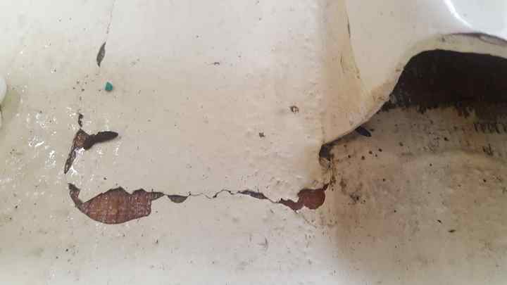 Close up shows open under seat foot rest