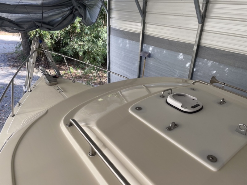 Covered previous holes with large starboard after filling and redrilling holes and rebedding handrails with 5200 to correct cabin roof leaks
