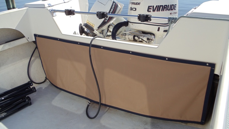 Custom made canvas cover in front of tanks and behind all the wires at the helm. Matches interior pieces.