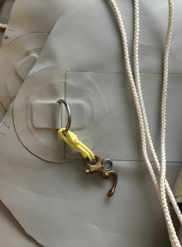 D Ring patch for rain fly over fore deck, Material is shelterRite and the patch is from Amazon, with a old jib hank and showing Dacron rope to tie the fly off to the Pulpit.