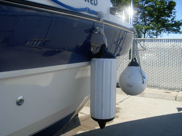 "Docking" fender configuration.  Round fender clipped to bow eye mounted as far forward as can be reached through helm window.