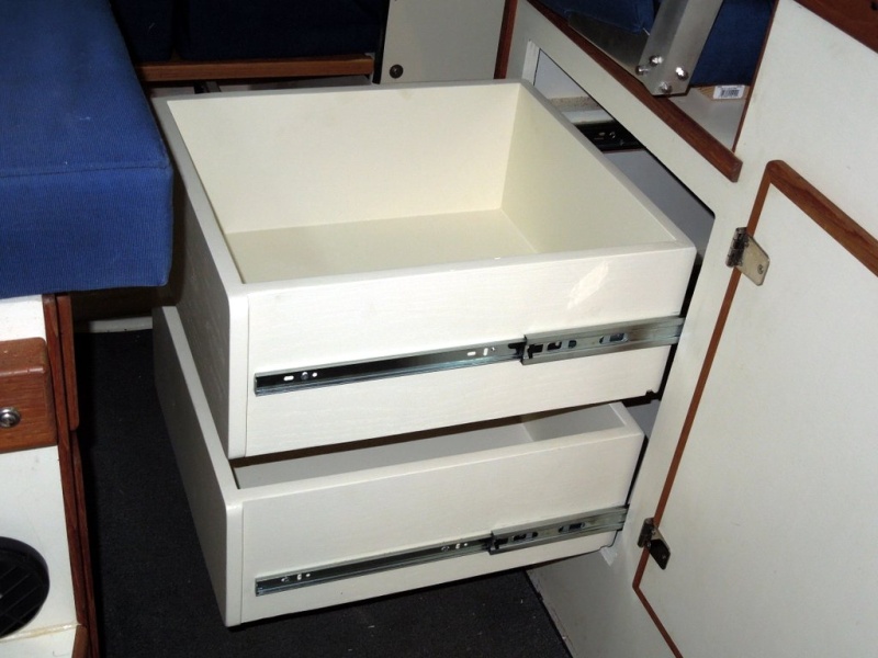 Drawers made from ?in veneer finished plywood painted with tint matched latex paint.  Assembled with glue and pneumatic brad nail gun.