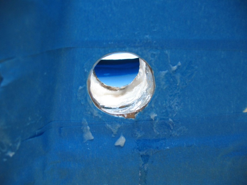 Filling the hole.  First I used a dental pick and a Dremel tool to remove the core for a good 1/2" beyond the drain hole.  Then I enlarged the hole in preparation for inserting a 1" ID (1-1/8" OD) fiberglass tube.  Then final sanding and cleaning, and I put a good coat of neat epoxy all around the hole.  After that (and will the tube prepped), I slowly built up the hole with thickened epoxy (colloidial silica).  I had to do it in layers so it would not get to hot as it kicked (but all in the span of a few hours so it was still plenty green for a chemical bond).
