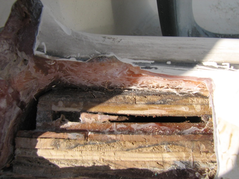 Final prep shows void in non marine plywood.  The top layer of glass was only about 1/8 to 3/16 " thick.  No rot or moisture in the core--but note that the wood in the transom ends before the top of the transom, and at the left side of the photo, instead of being carried all of the way to the side of the transom.  In other words the poorly laminated spash well molding is taking a lot of the load of the engine thrust, instead of the sides of the hull.