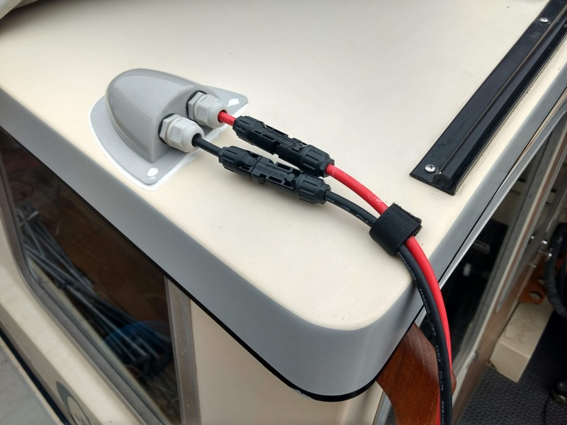 Finished up the cabling/connectors where the panel will connect to the boat. The cables are extension cables going to the panel which is leaning up against the house. When the rack/solar-panel is mounted to the roof the cables directly from the panel will plug right in without the extensions. (I have to leave the rack off for my boat cover to fit).

The velcro strain relief is screwed down under one of the bimini top snaps.