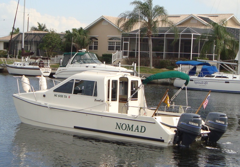 Flag poles are installed in angled fishing rod holders.  The staffs are 48" long, so they are 42" out of the transom.