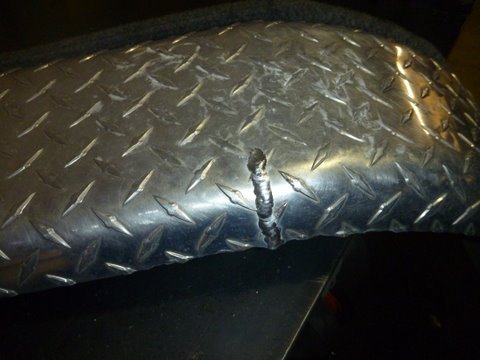 Float -On trailer's extremely thin aluminum fender we climb into the boat using this fender and it's rear support