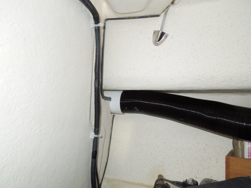 Forward air return vent in V-birth, temporary vent hose attached leading to forward area of birth.