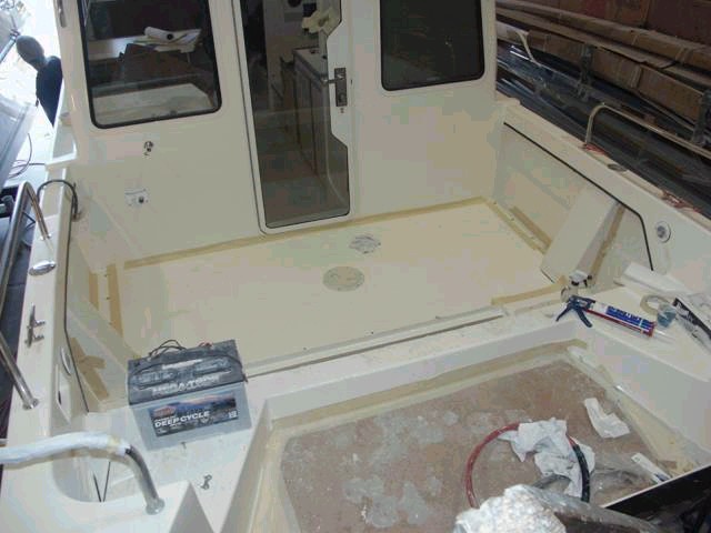 Fuel tank lid, screwed to cleats and sealed.  The lid can be removed easily without cutting the deck.