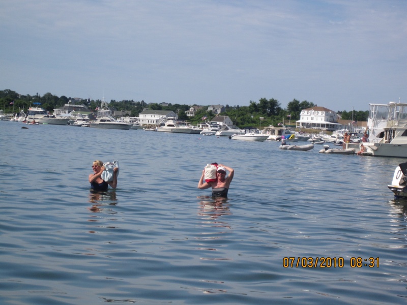 Ginny and Jess wading ashore  to go to the beach. They got offered a dingy ride by two nice guys but decided to hoof it anyway in Block Island. You can just see the back of Will-C to the right. To cheap to call for the three dollar launch