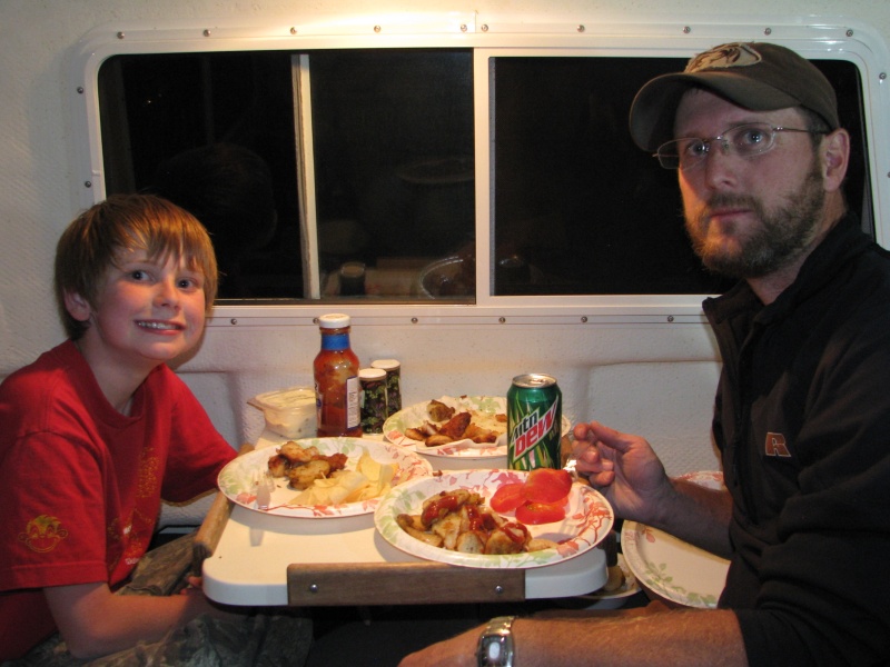 Grayson and his dad Scott, eating the catch.