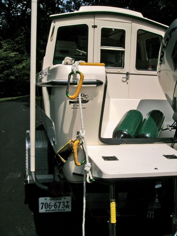 Hand holds for the swim step.  Three Harbor Freight aluminum caribeaners (99 cents each)with soft grip wrapped in yellow Rescue Tape for a watertight seal.  A fourth caribeaner attaches the rope to the ladder.  I will put a 6" float on the end of the line in the water for visual marking.  Total cost less than $10.