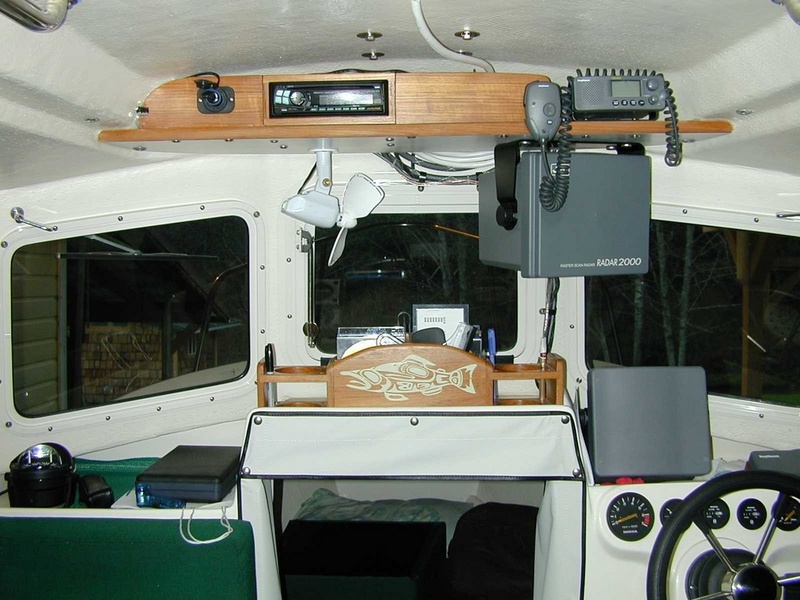 Helm layout, extra 12 volt plug upper left for my son's laptop for playing movies.  Center console for CD storage, beverages, tide books, pens, etc. (Mason C. Bailey)