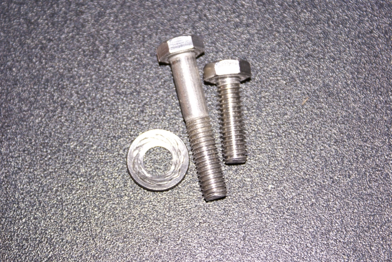 Helm Seat - Slider bolts.  These are from the "corrected" second shipment of the seat.  The one longer bolt was wedged in the apparently re-drilled and stripped hole in the seat.  See next photo.