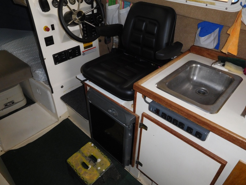 Helm Seat turned to aisle is used for extra seating when guests visit for Dock Tails.
Foot support is an RV step which is normally allows stepping from swim step.