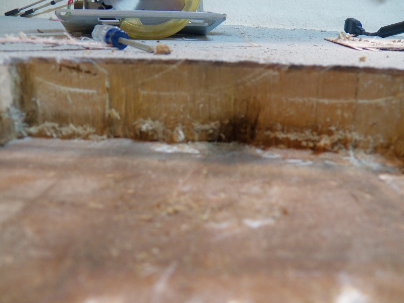 Here is the scariest part.  This is looking towards the center of the boat once all of the balsa was cleaned out of the initial section.  Even though the wood is showing less damage overall, there is a spot of wet rotted wood that is basically forming a tunnel against the outer skin of the hull.  Water in this area can be pumped into other areas by the hull pounding.  I found the adhesion to be very good, so I'm hoping this doesn't go far.  But the cutout has to be expanded until I find the end of the damage.  I made quite a few cuts, expanding by about an inch at a time, which is the amount that my vibrating saw could easily remove.
