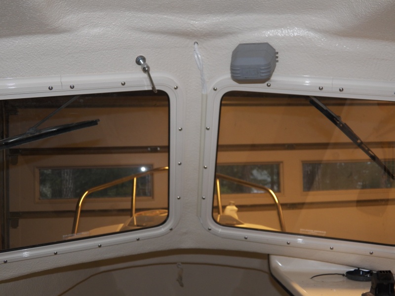 Here is the wiring placed in cream colored conduit running right up the side of the window.  I used this on the transom to cover the depth sounder cable and thought I would try it here.