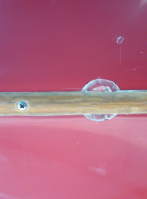 Here's a closeup. I don't have a clue on this. The spot is approx. 1 inch in diameter and is below being flush with the Gelcoat surface approx. .025" and appears to be hard as a rock when probed. The brass keel guard is not compromised or damaged and appears to be bedded in 5200. I'm at a loss on
this one! The boat has been to Lake powell once and Bellingham and the San Juans twice, so it's not like it's been in the water constantly. HELP!