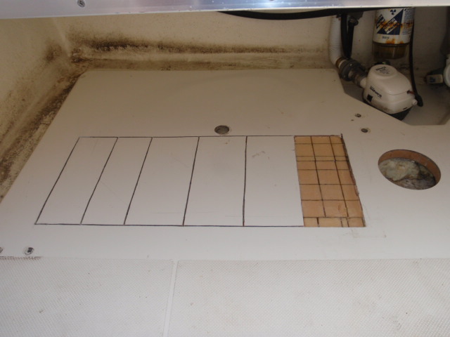 Hole for deck plate to the right.  Factory hole to insert foam under the cockpit floor on top.  The area of the cockpit floor that I opened up hoping to dry out the core, in the center.
