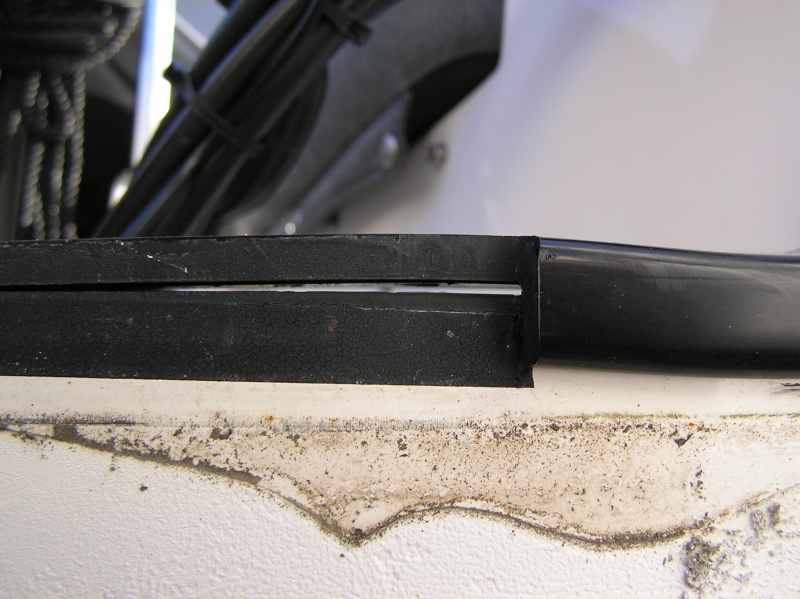 I can now more easily address this.  The transom cap coming unglued.  Plan is some black 4200 and clamps.