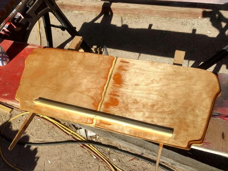 I made a cover to fill the opening to the anchor locker in hopes of keeping water off the V-berth cushions when hauling in the rode/chain with the windlass.

The cleat on the back hangs over the existing fiberglass bulkhead that forms the locker. With 2 coats of epoxy covering the back water "should" just shed right off into the bottom of the locker.