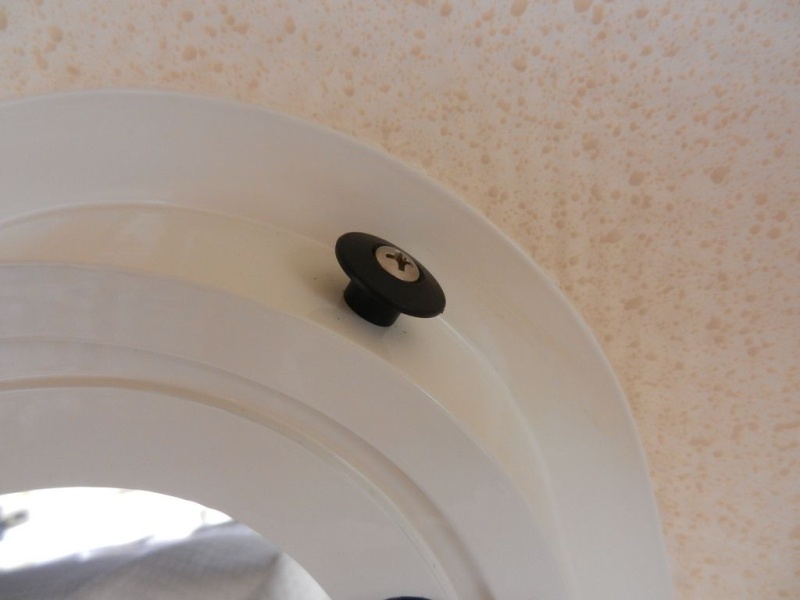 I used a kayak "bungee button" 

(http://kayakfishinggear.com/bungeebutton.aspx) 

at each corner of the window frame.