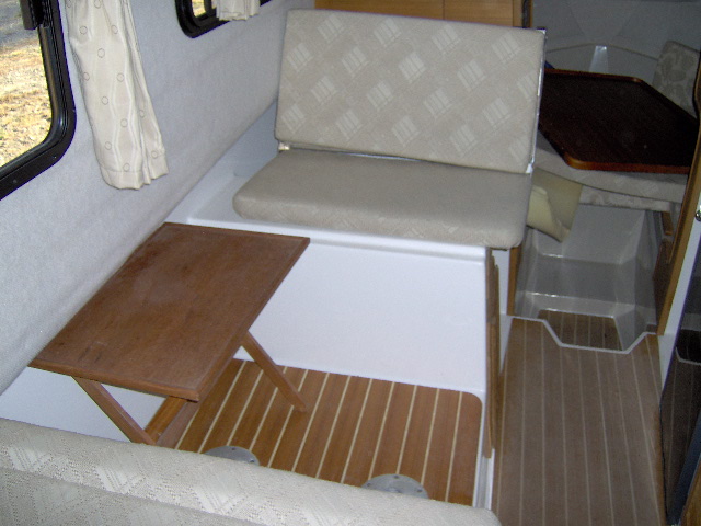 I'm going to sleep here, table top will go to the v-birth in the morning. It sure opened up the galley. we will leave the legs for the table at home. Two teak tv trays. one in cock pit , one in cabin.