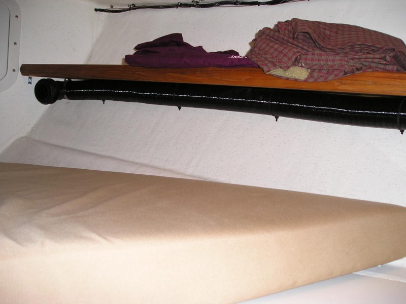 In the V berth the duct runs under the starbd shelf.