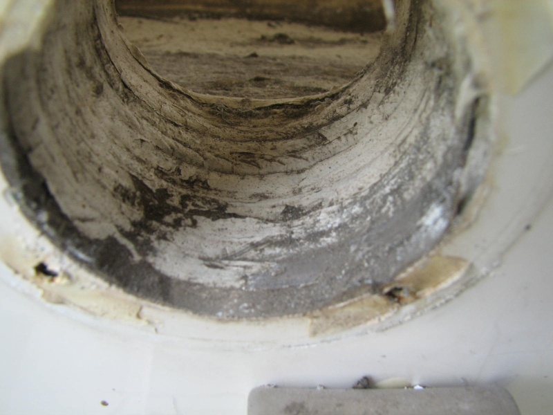 initial photo after the \"flapper\" valve is taken off.  There is gel coat smeared over the wood boring, and some voids.