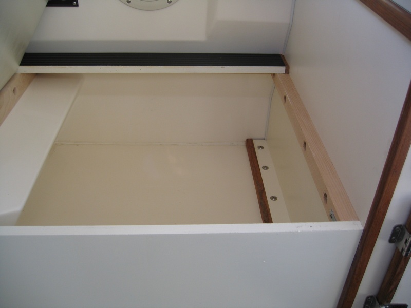 Inside of helm storage box showing through-bolted cleats.