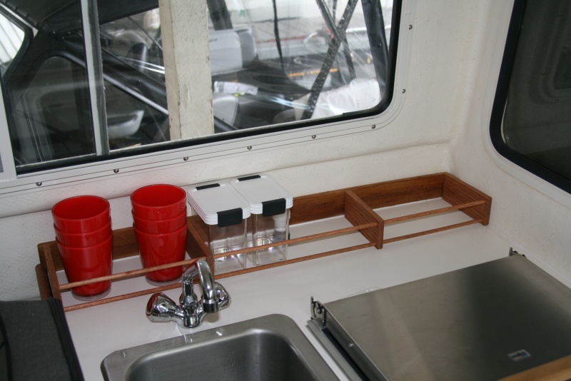 Inspired by others - galley rack made with 2 1/2" wide oak with two 3/8" dowels running the length.
