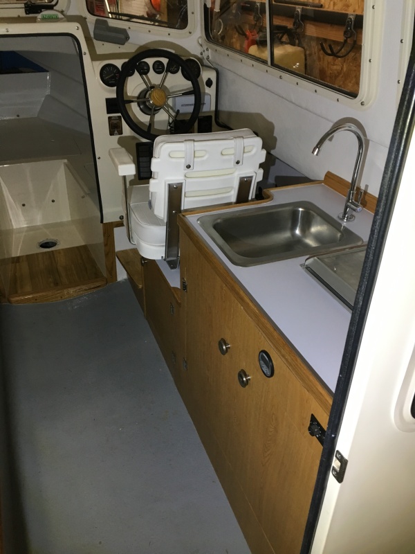 Installed faucet connected to forward water tank and water pump. Also ran the water hose to the stern for a washdown hose.