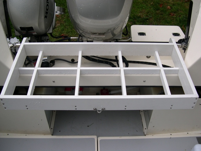 Installed rack.  Outside dimensions are 17.5" by 37".  Constructed with 1x4 and 1x2 plastic lumber (outdoor molding) found at Home Depot thanks to Tyboo.  Note cross pieces installed to reduce water entering cockpit from the motor well when cooler is in place.