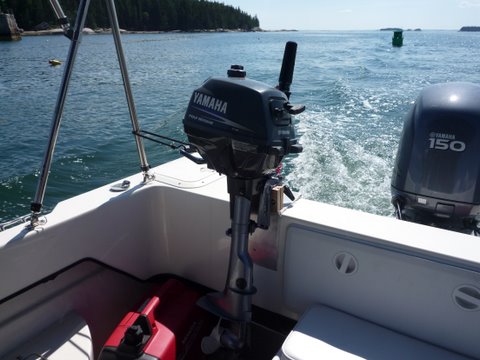 Junior our 2 1/2 hp Yamaha four stroke dink motor. Bracket through bolted into the compartment with just one bolt.