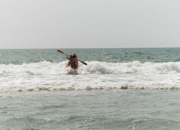 Kathy riding waves at Ocracoke, NC