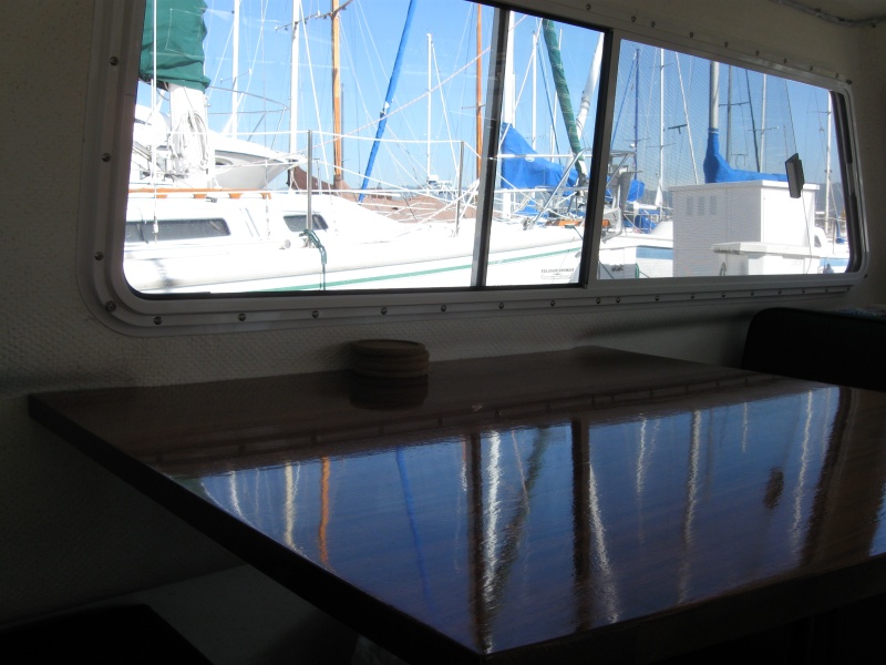 Larger table, mahogany, ten coats varnish, scribed to contours of boat