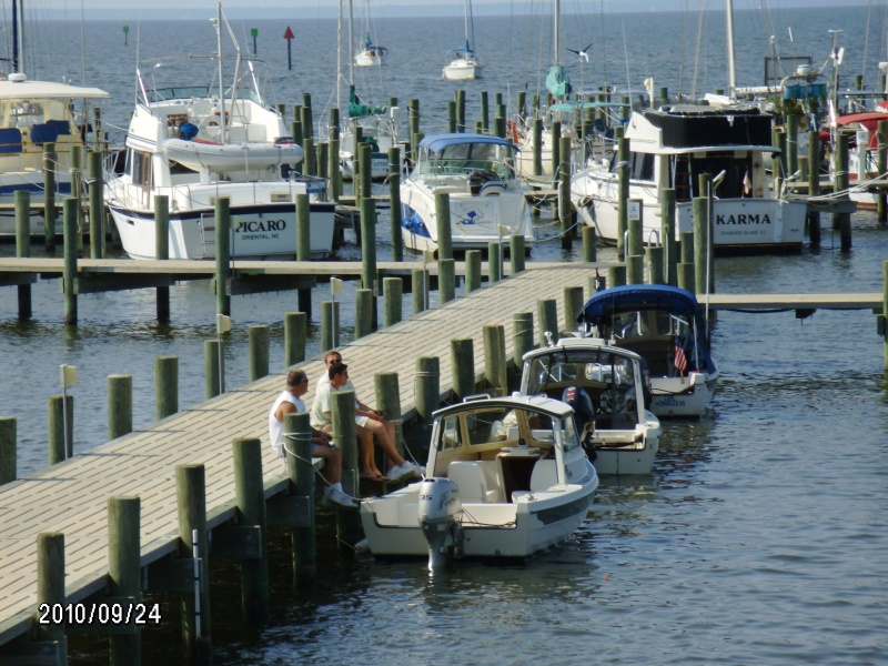 Larry, Bill & Tivo sitting on dock trading boat stories..Whittaker's Pointe Marina