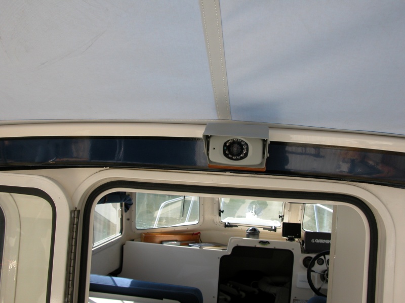 LCD Backup Camera above cabin door. The small 'black dot' to the left of the lense is the mic pickup. I use the mic to monitor the cockpit crew for docking or other feedback.