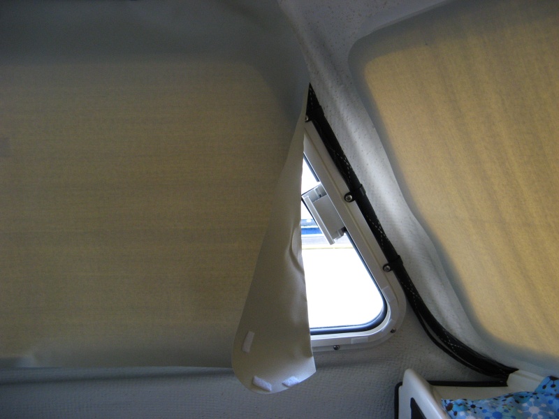 Leading edge of large side windows needs folding back when rolled up.  This leaves a crease but we aren't that picky