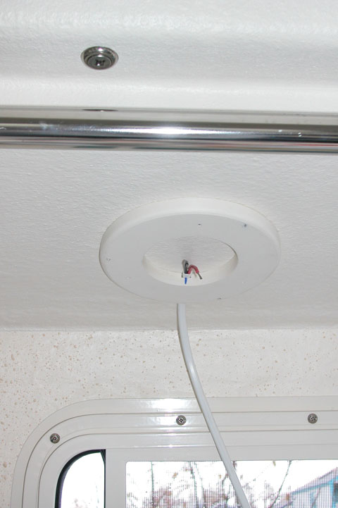 Light mount over dinette table, a much needed addition.  Mounting ring made out of King Starboard.  Ring is easily replaced if new light fixture is required.
