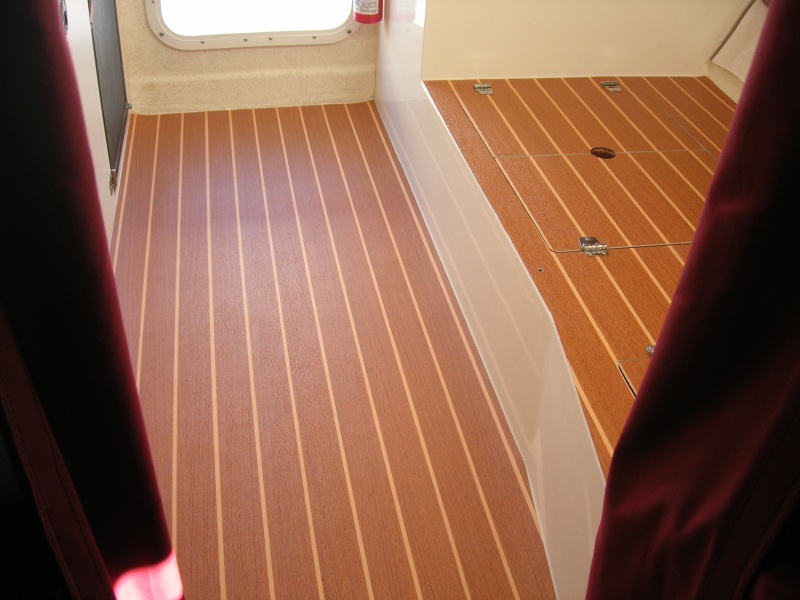 Looking aft without forward dinette seat in place.  Had to remove it to properly template that area, trim the material, and glue it in place.  The hatch hinges will also assist in holding the dinette section in place.  The cabin floor section is floating.