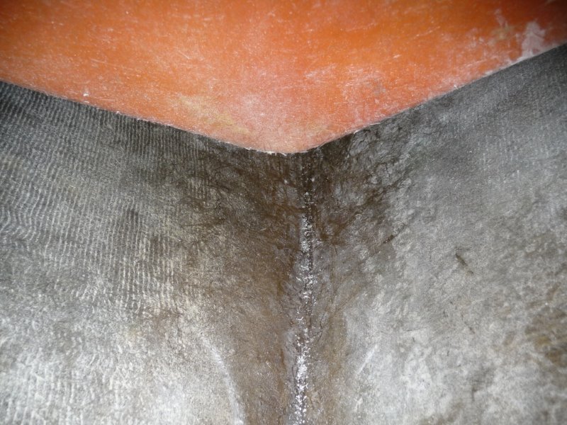 Looking straight down at the inside of the stem and a bit aft. The orange is the backside of the forward "V" storage locker bulkhead. There  is about a 2" clearance under the "V" storage locker.