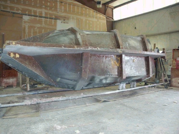 Lower half in the mold (this could be any boat, hope it's ours)! 2/23/04