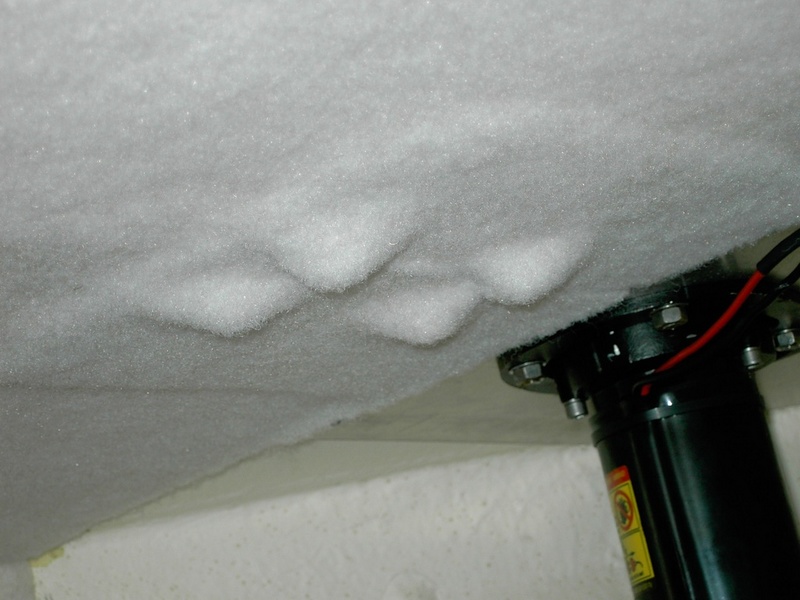 (Lynn Marie) arpet layed over nut/bolt ends and winch backing plate just above rope locker bulkhead. Carpet stretches well over small lumps.