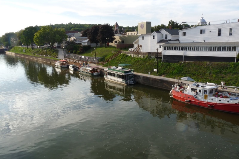Lyons, NY. Two Bears is the 2nd boat from the left on the lower floating dock. Many small towns on the western end of the canal provide a low floating dock suitable for small boats.  They also often provide power and restroom facilities.  In this case we used the fire hall which is the left end of the white building.  Being an old volunteer fireman, Chuck had a good time visiting with the volunteers that staff the station.